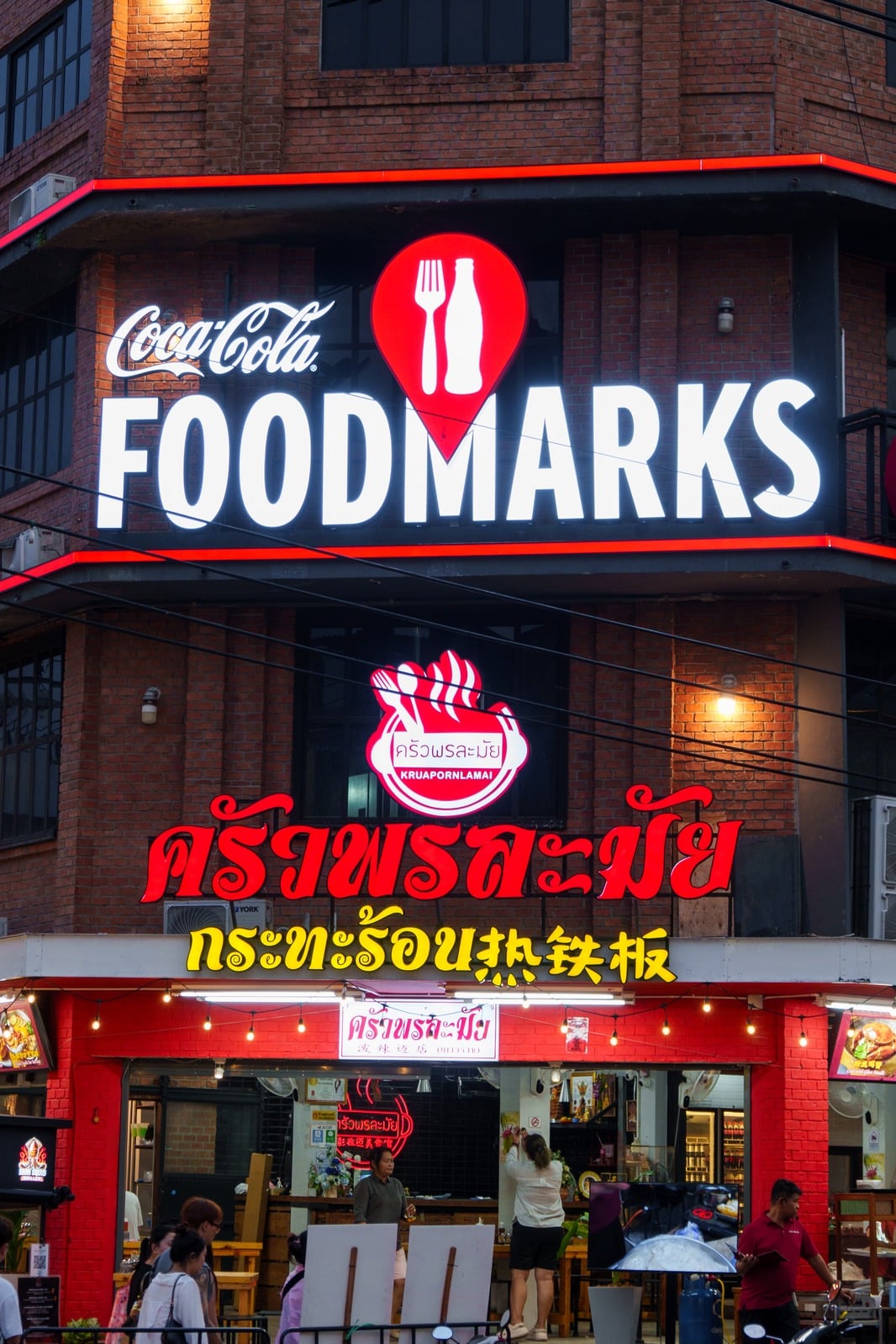 Coca-Cola FOODMARKS illuminated red facade sign at night