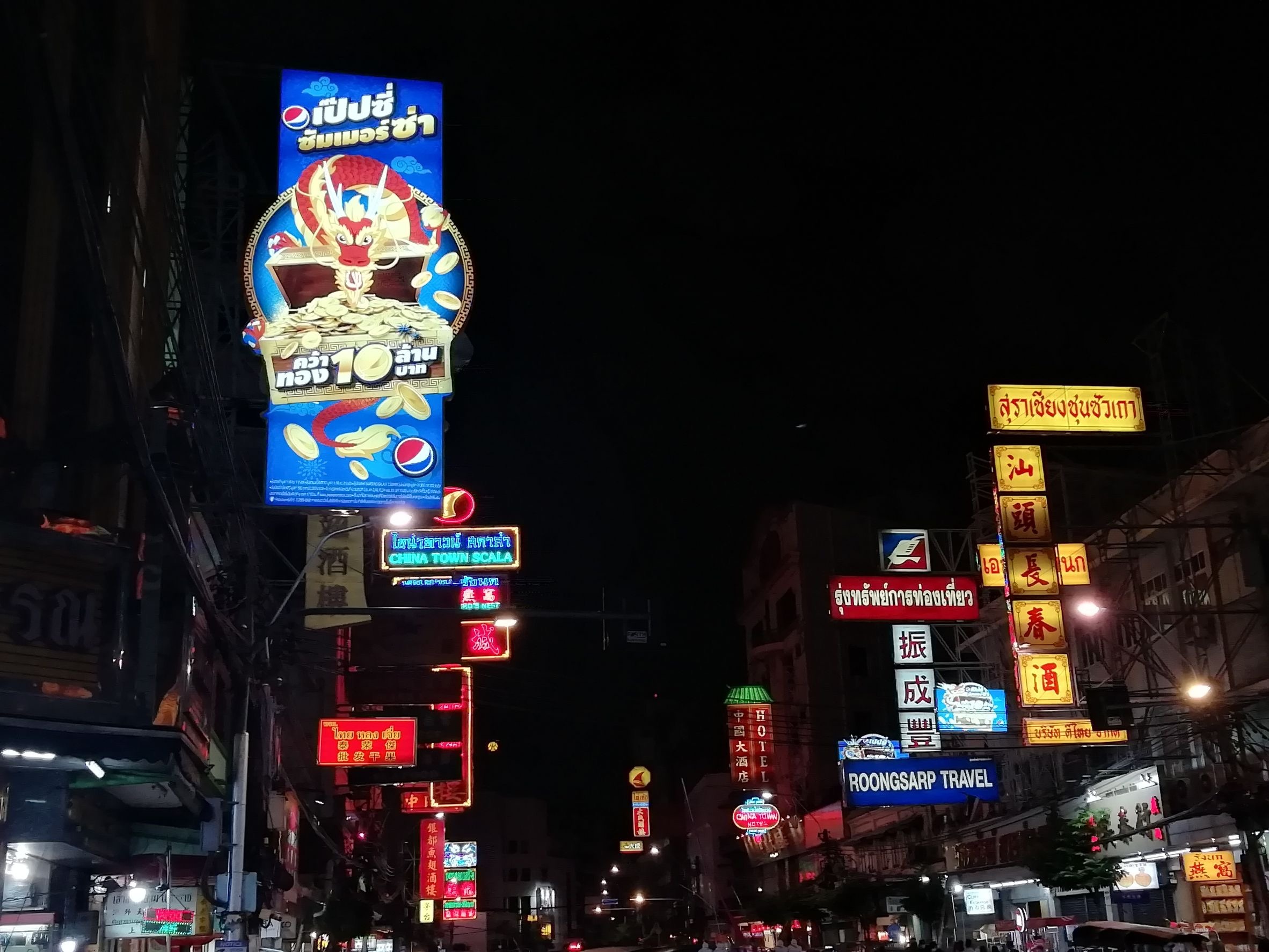Pepsi neon dragon sign amid the layered neon of Bangkok Chinatown at night