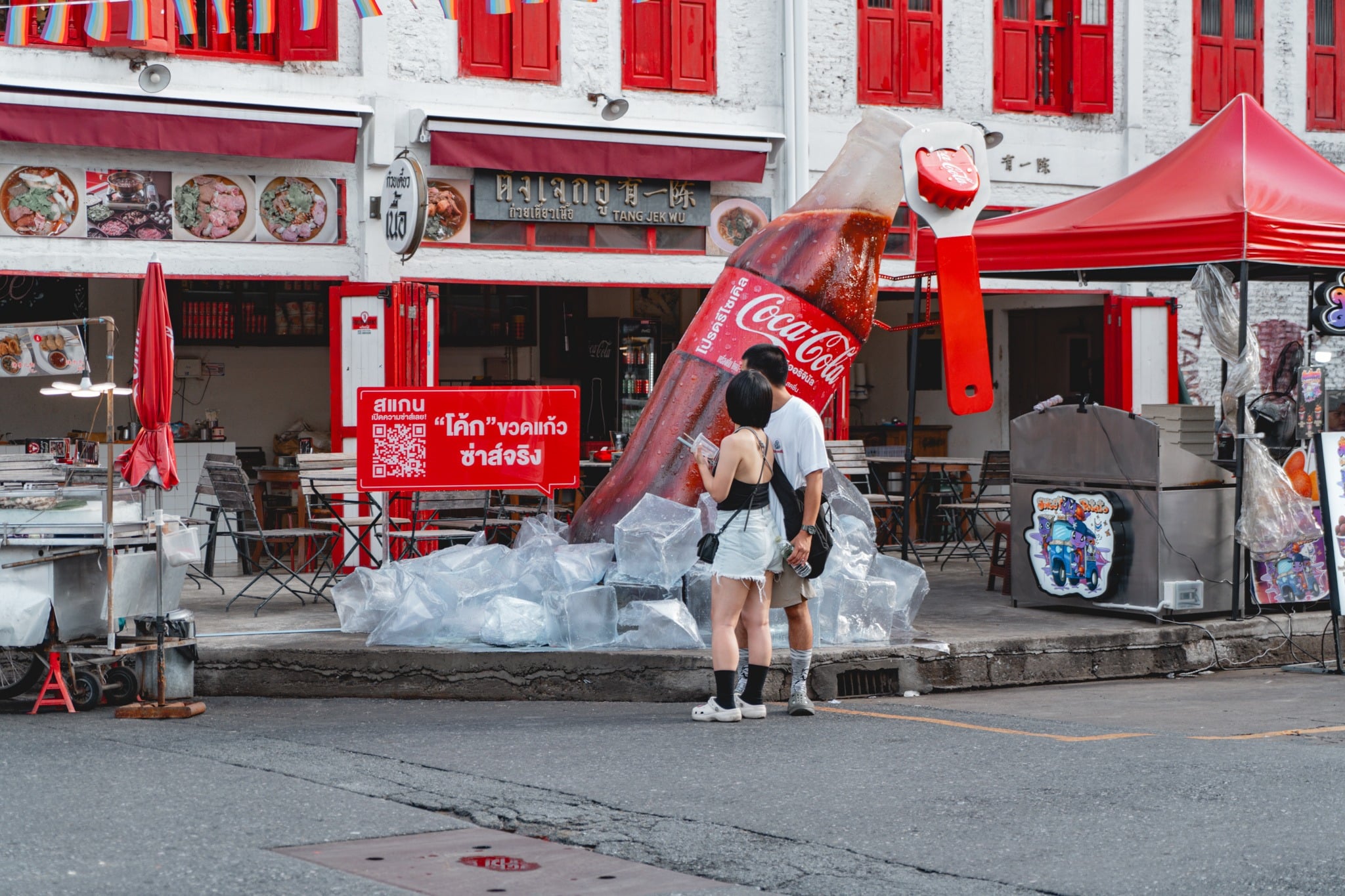 Giant Coca-Cola bottle pouring into ice, a Chinatown street installation
