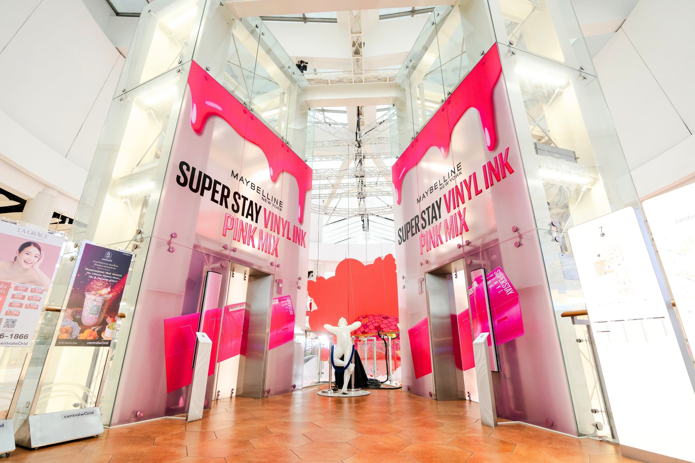 Maybelline Super Stay Vinyl Ink hot-pink dripping mall entrance takeover